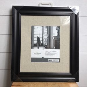 8x10” brown faux wood frame with linen mat.